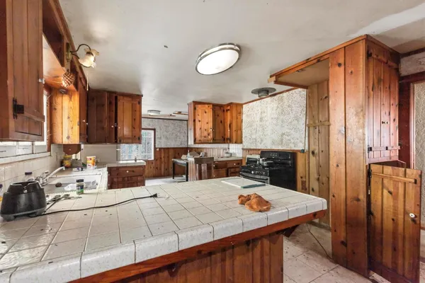 a kitchen with stainless steel appliances a stove and a refrigerator
