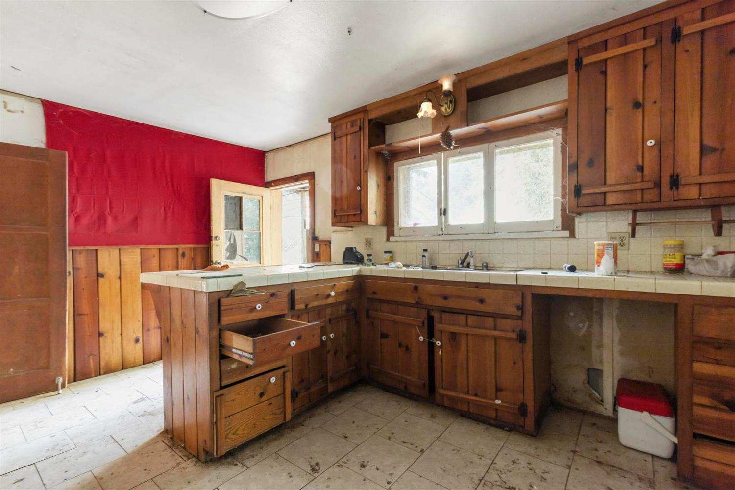13887 La Porte Road Strawberry Valley, CA 95981 - Photo 15 of 37 a kitchen with a sink window and cabinets