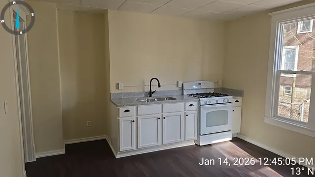 a kitchen with granite countertop a sink and a stove top oven