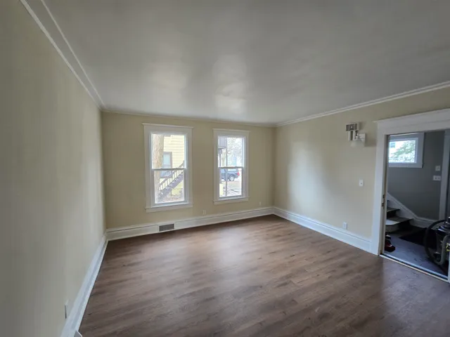 a view of room with window and hardwood floor