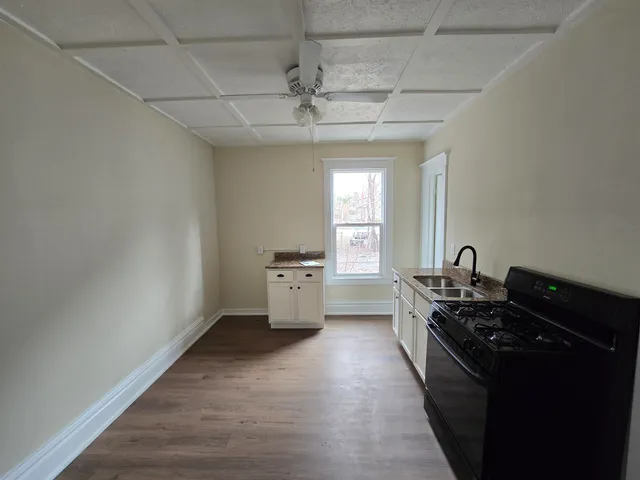 a kitchen with granite countertop a stove and a refrigerator