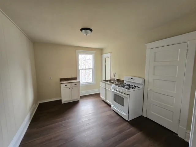 a kitchen with a stove and white cabinets