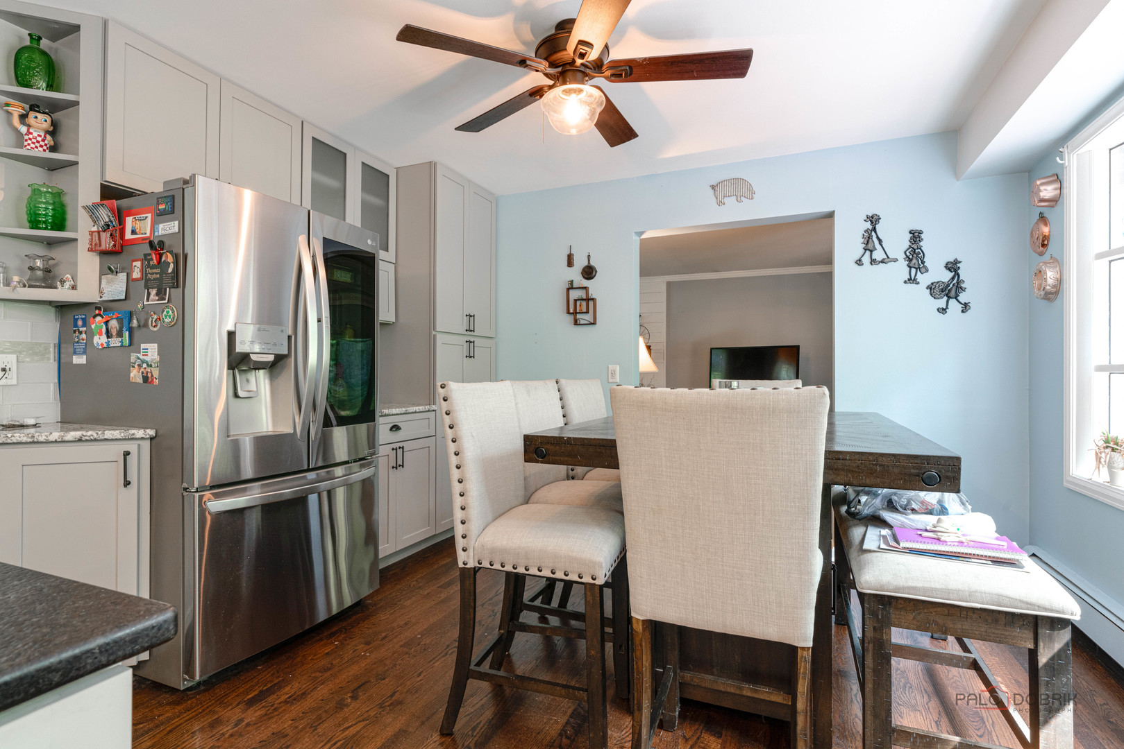 820 Black Partridge Road McHenry, IL 60051 - Photo 11 of 34 a kitchen with stainless steel appliances a refrigerator a stove a dining table and chairs with wooden floor