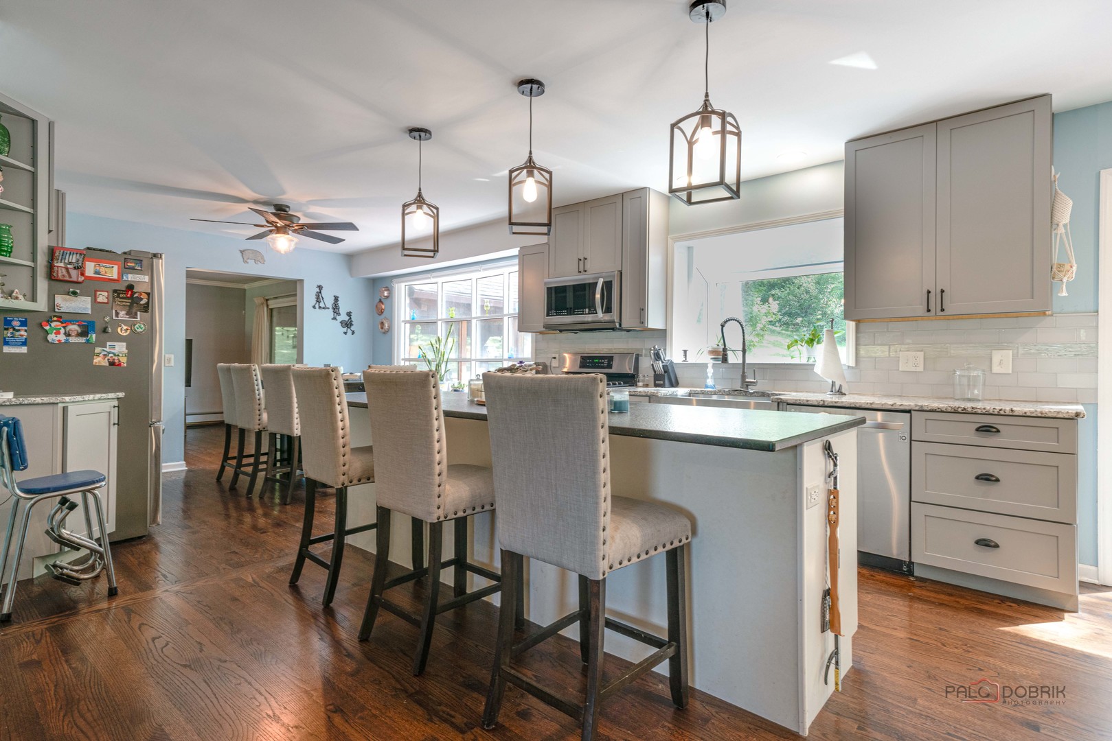 820 Black Partridge Road McHenry, IL 60051 - Photo 12 of 34 a kitchen with stainless steel appliances kitchen island granite countertop a table chairs and a wooden floor