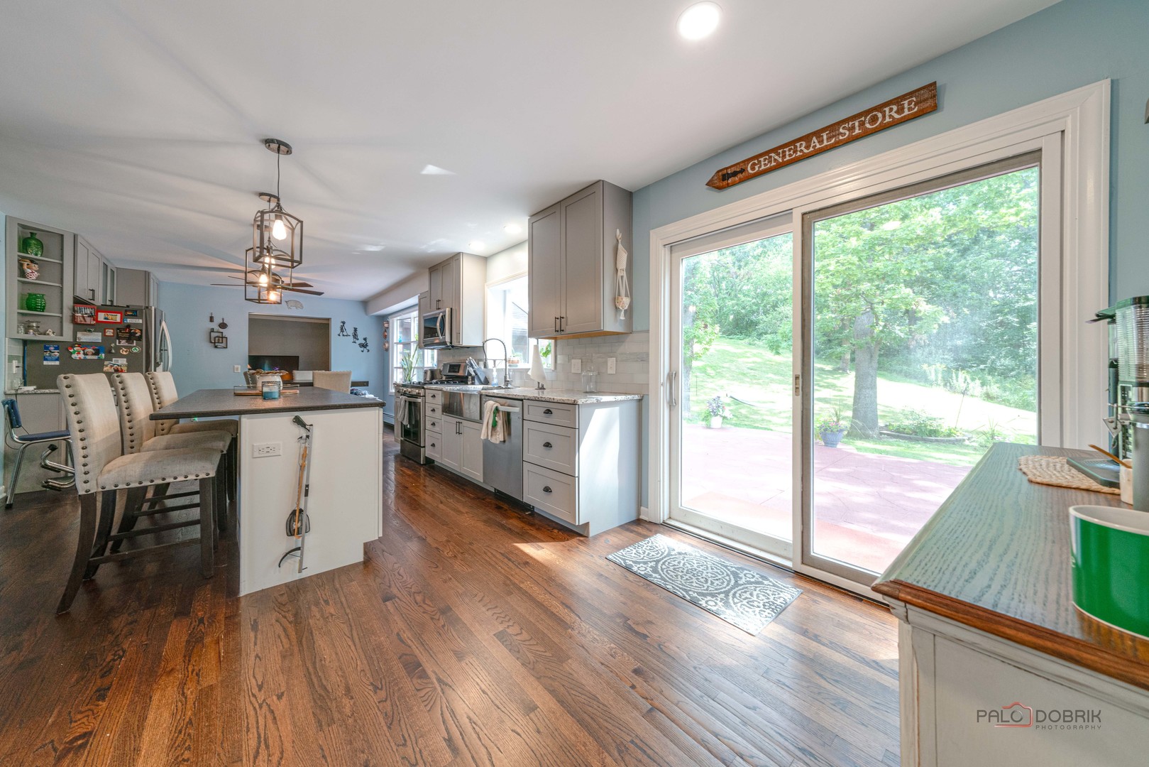 820 Black Partridge Road McHenry, IL 60051 - Photo 13 of 34 a open kitchen with granite countertop a stove top oven sink and white cabinets with wooden floor