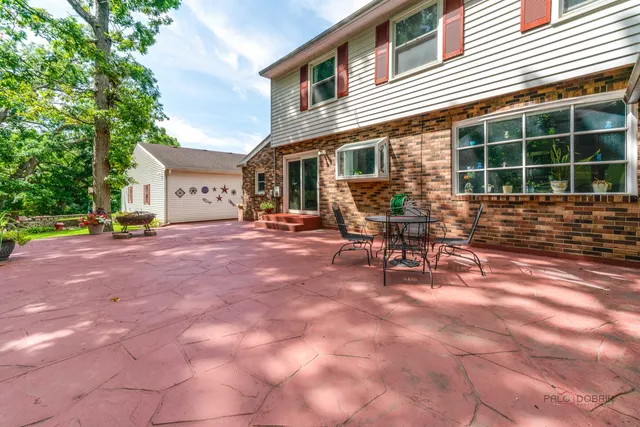 a view of a house with backyard and sitting area