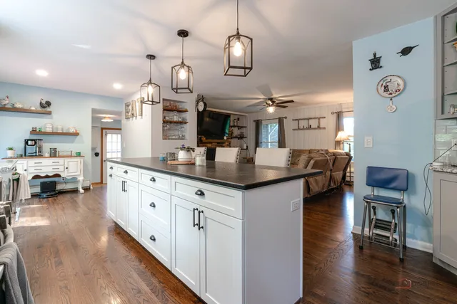 a kitchen with stainless steel appliances kitchen island granite countertop a large island in the center