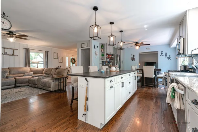 a large living room with fireplace furniture and a wooden floor