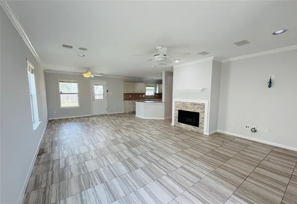 an empty room with wooden floor and fireplace