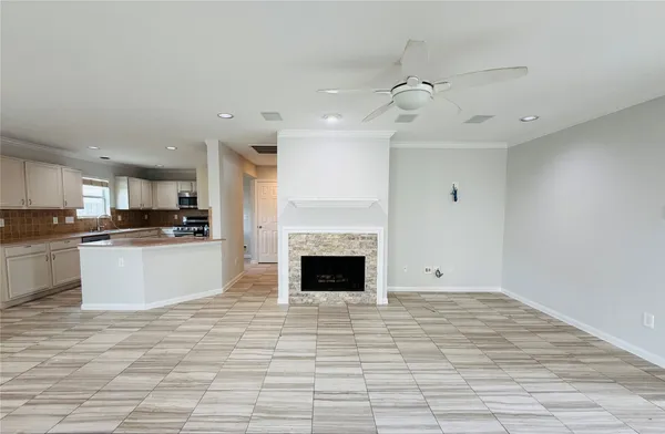 a view of kitchen with kitchen island a counter top space a sink and cabinets