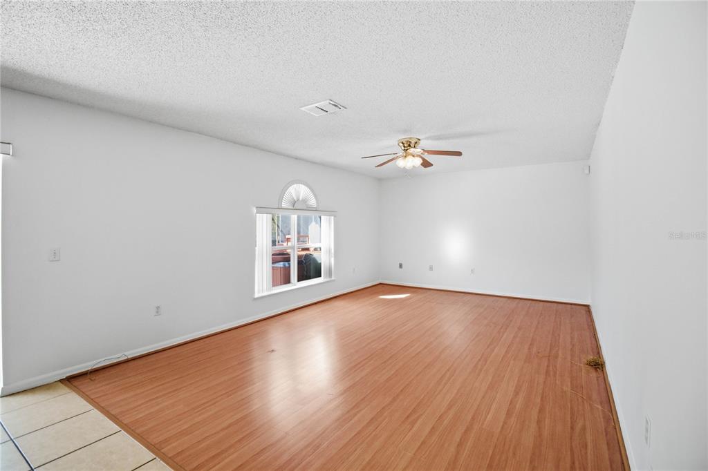 206 Taranto Way Kissimmee, FL 34758 - Photo 8 of 45 a view of a room with wooden floor and white walls