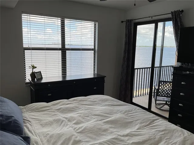 a bedroom with a bed and a large window