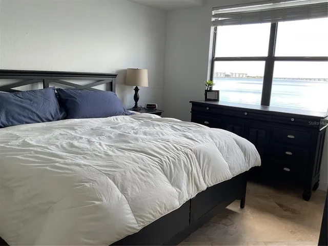 a bathroom with a sink mirror and a window