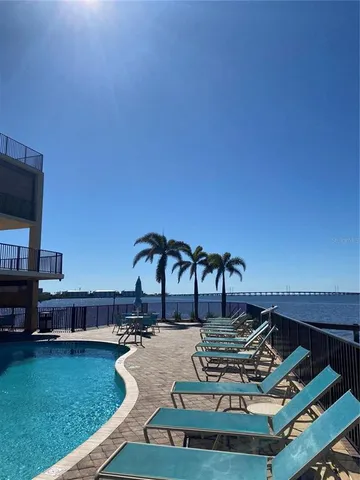 a backyard of a house with chairs and table