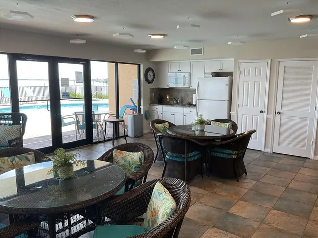 a living room with furniture and floor to ceiling windows