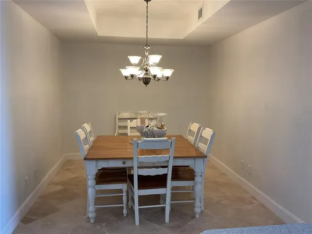a view of a dining room and hall with furniture