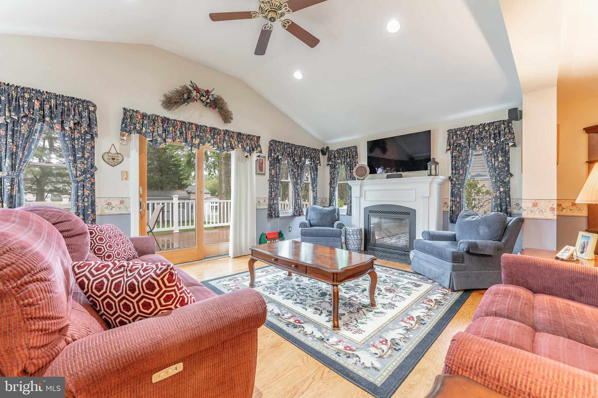 209 Beechtree Drive Broomall, PA 19008 - Photo 15 of 61 a living room with furniture a flat screen tv and a fireplace