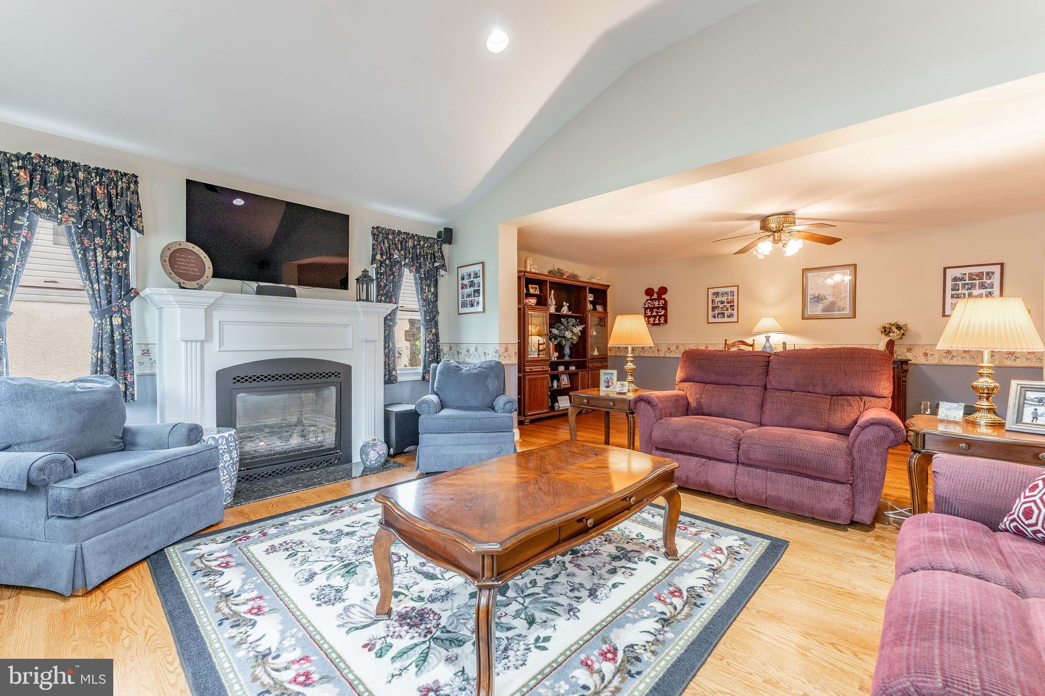 209 Beechtree Drive Broomall, PA 19008 - Photo 16 of 61 a living room with furniture a flat screen tv and a fireplace