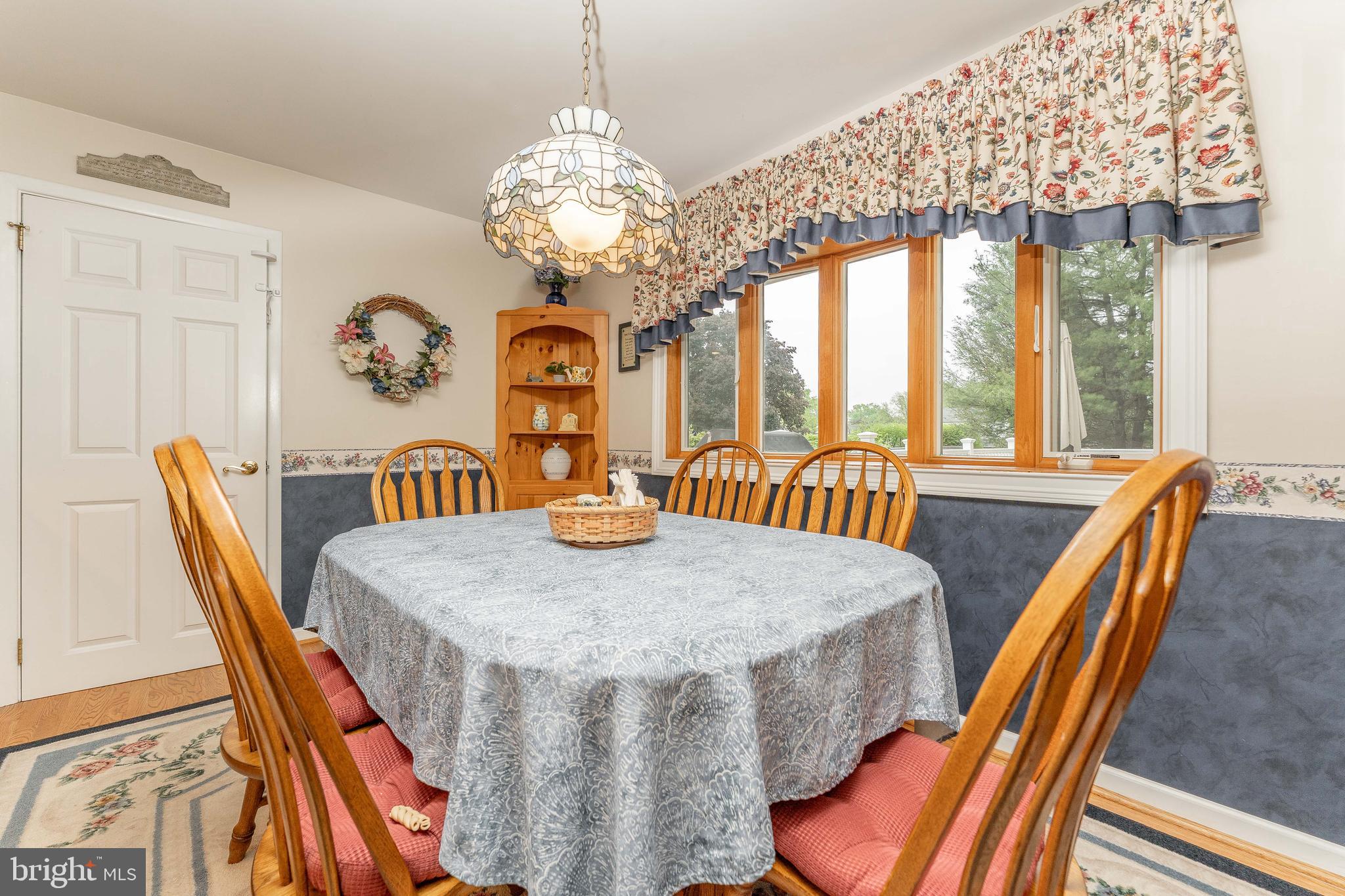 209 Beechtree Drive Broomall, PA 19008 - Photo 27 of 61 a view of a dining room with furniture a chandelier and large windows