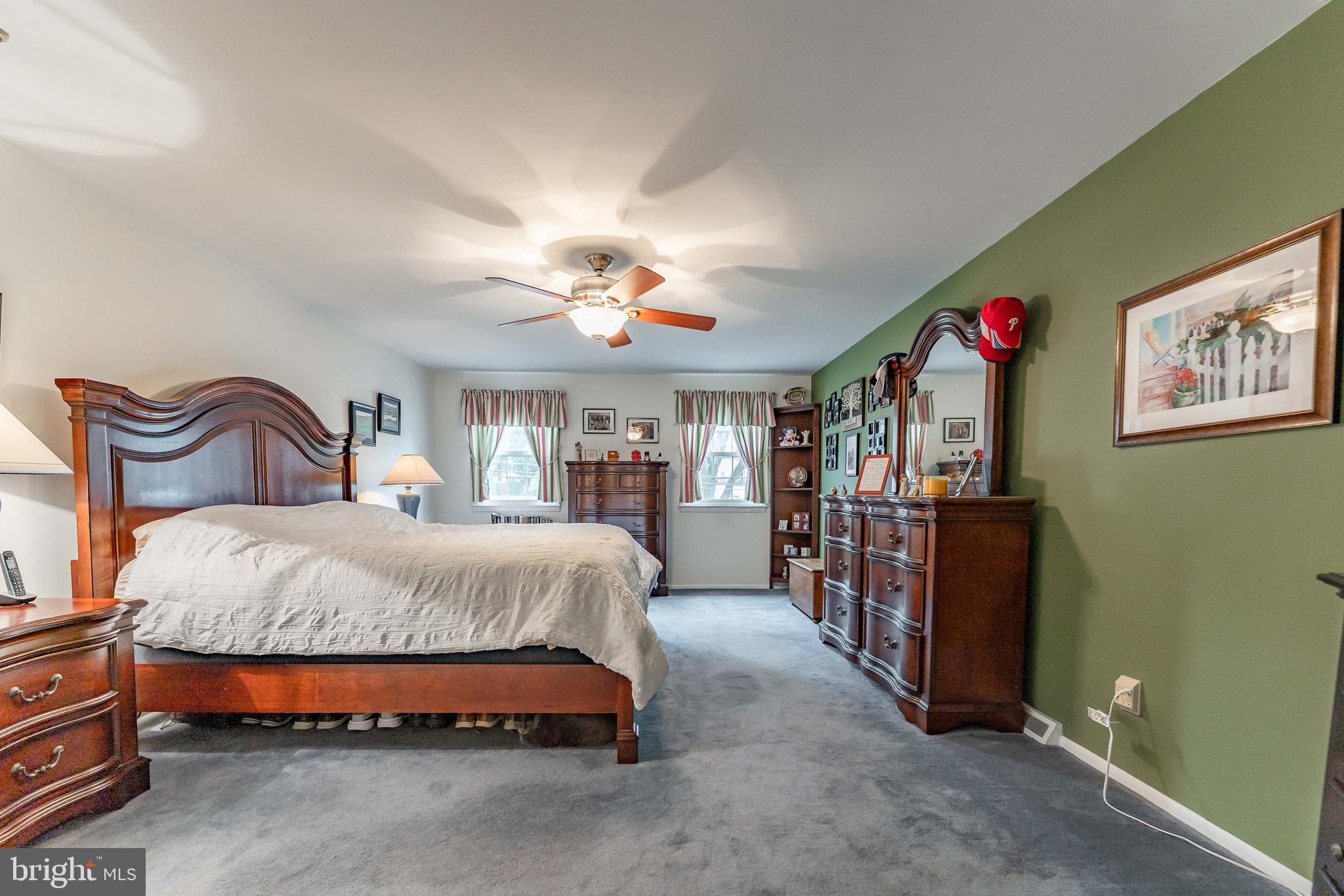 209 Beechtree Drive Broomall, PA 19008 - Photo 36 of 61 a spacious bedroom with a bed and a chandelier