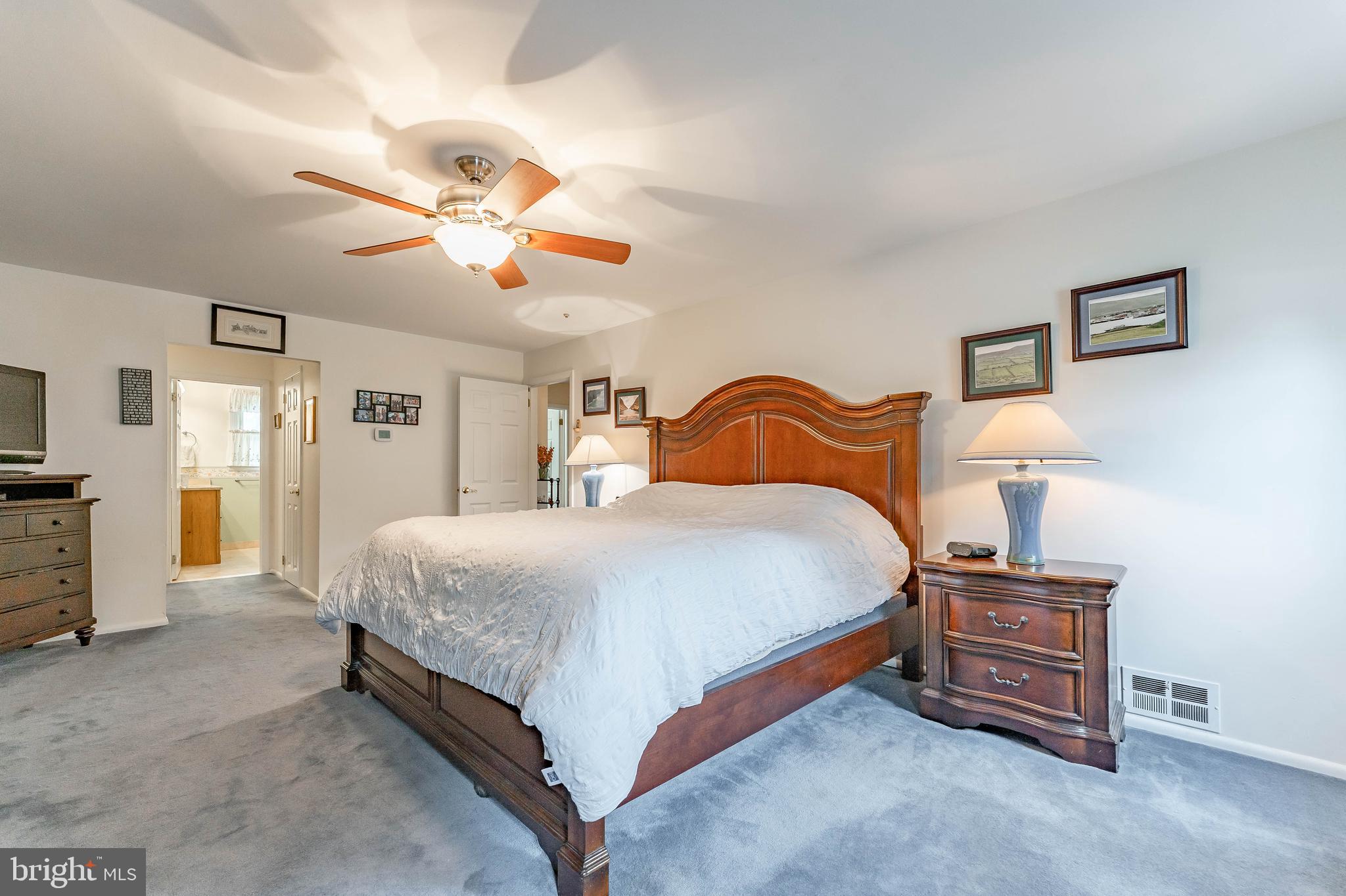 209 Beechtree Drive Broomall, PA 19008 - Photo 37 of 61 a bedroom with a bed and a chandelier