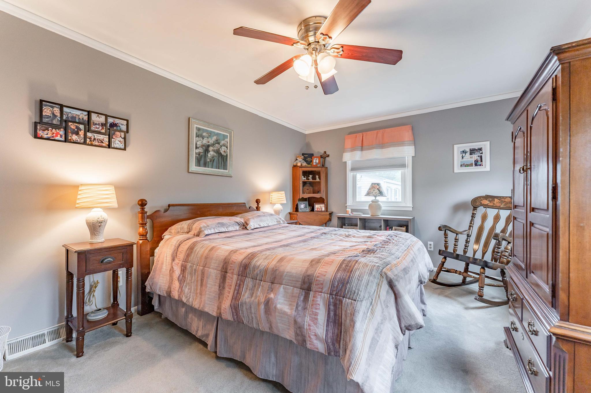 209 Beechtree Drive Broomall, PA 19008 - Photo 42 of 61 a bedroom with a bed and a chandelier