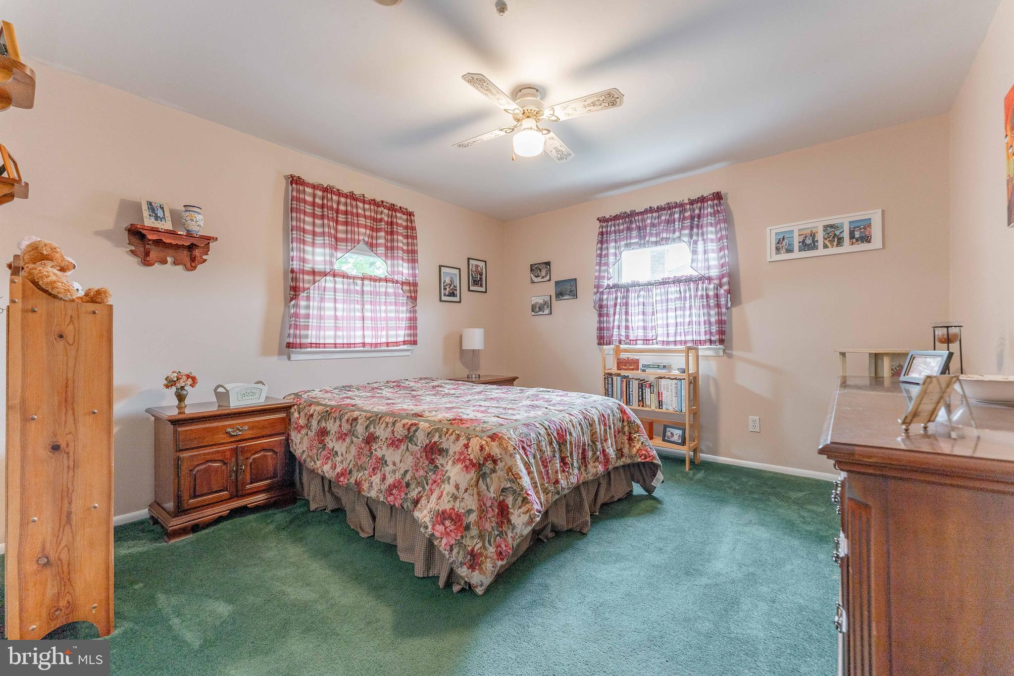 209 Beechtree Drive Broomall, PA 19008 - Photo 47 of 61 a bedroom with a bed and a chandelier