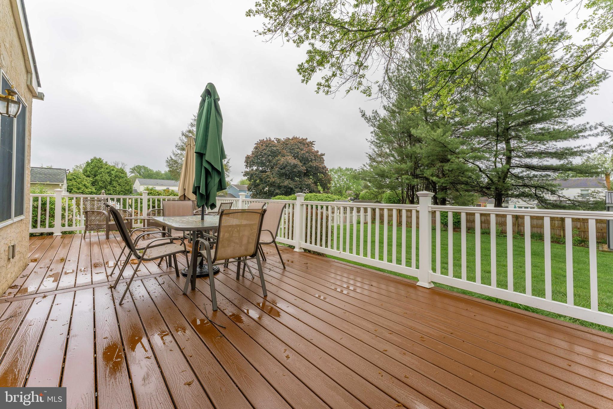 209 Beechtree Drive Broomall, PA 19008 - Photo 58 of 61 a view of a roof deck with table and chairs a barbeque with wooden floor and fence