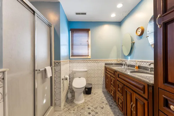 a bathroom with a sink a toilet and shower