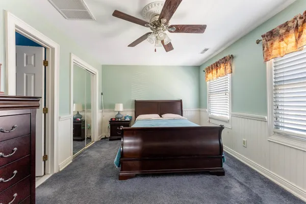 a bedroom with a bed and a ceiling fan