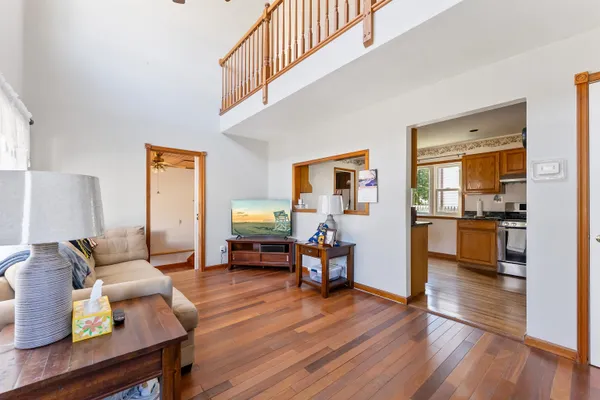 a living room with furniture and wooden floor