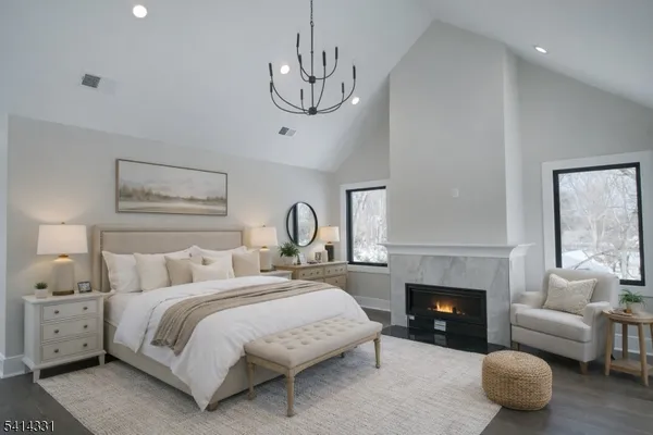 a spacious bedroom with a bed and a fireplace