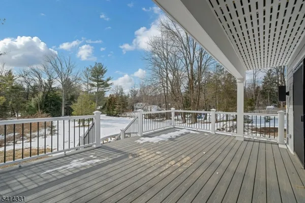 a view of roof deck with a barbeque and wooden stairs