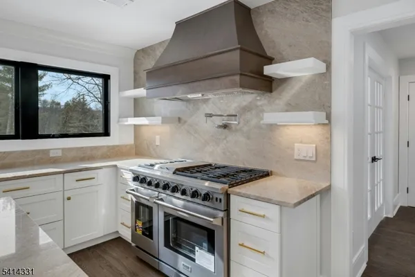 a kitchen with cabinets and wooden floor