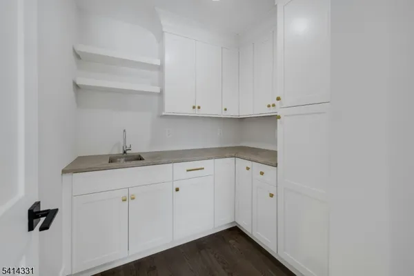 a kitchen with white cabinets and a sink