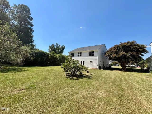 a view of a house with a yard and garage
