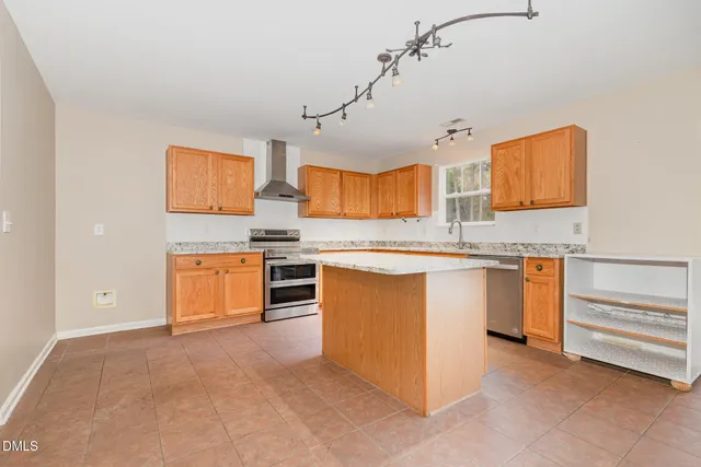 a kitchen with stainless steel appliances granite countertop a stove and a sink