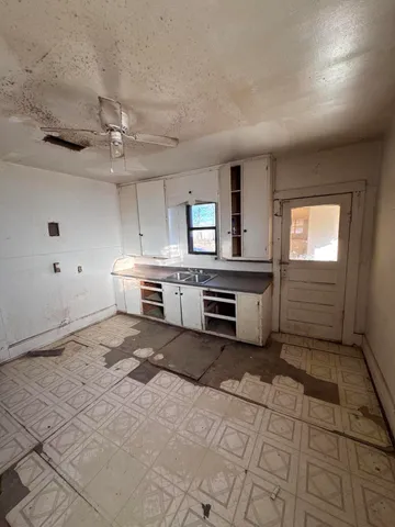 a view of a storage & utility room with a sink
