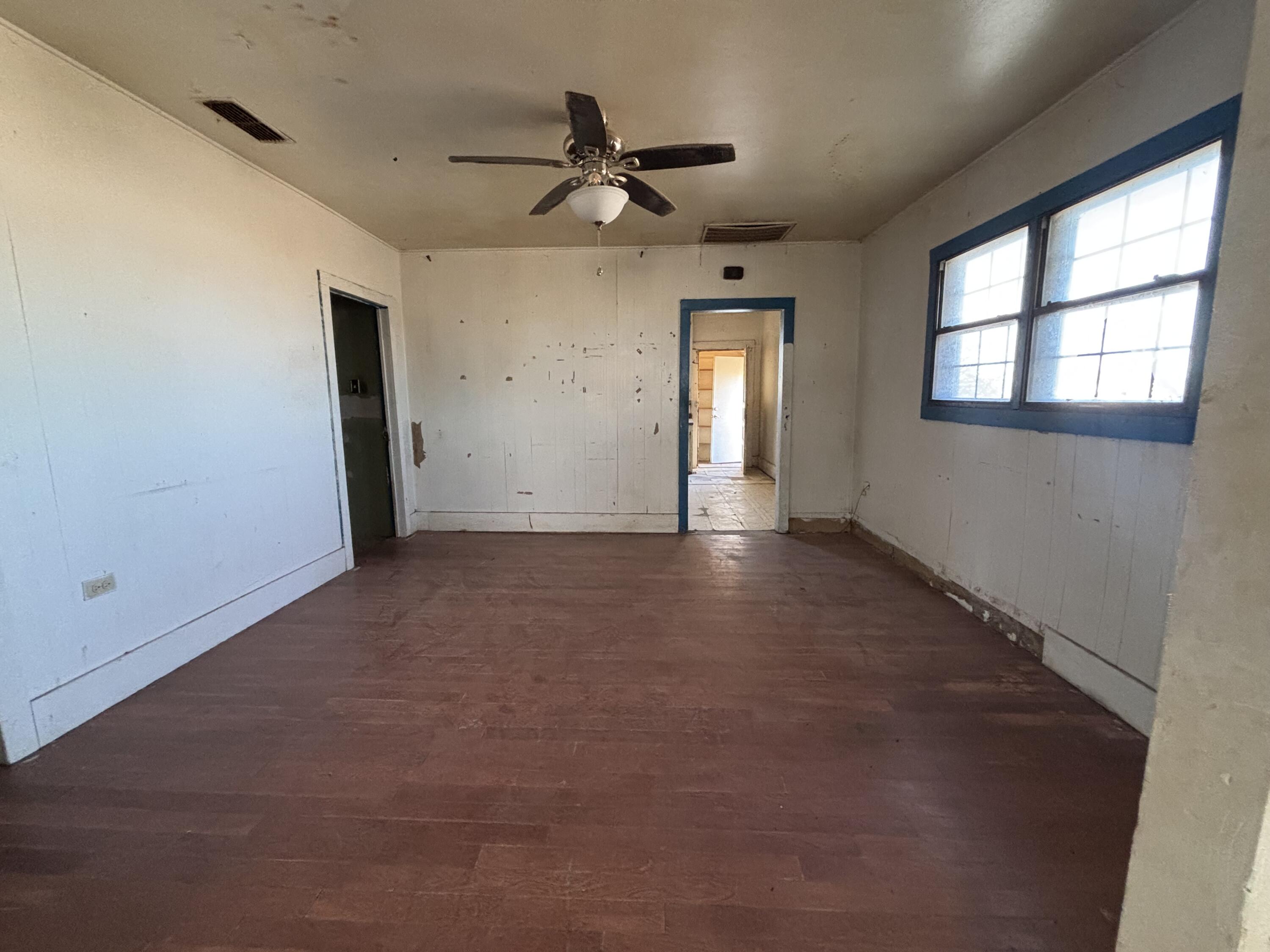 311 11th Street Ralls, TX 79357 - Photo 6 of 21 a view of a livingroom with a ceiling fan & windows