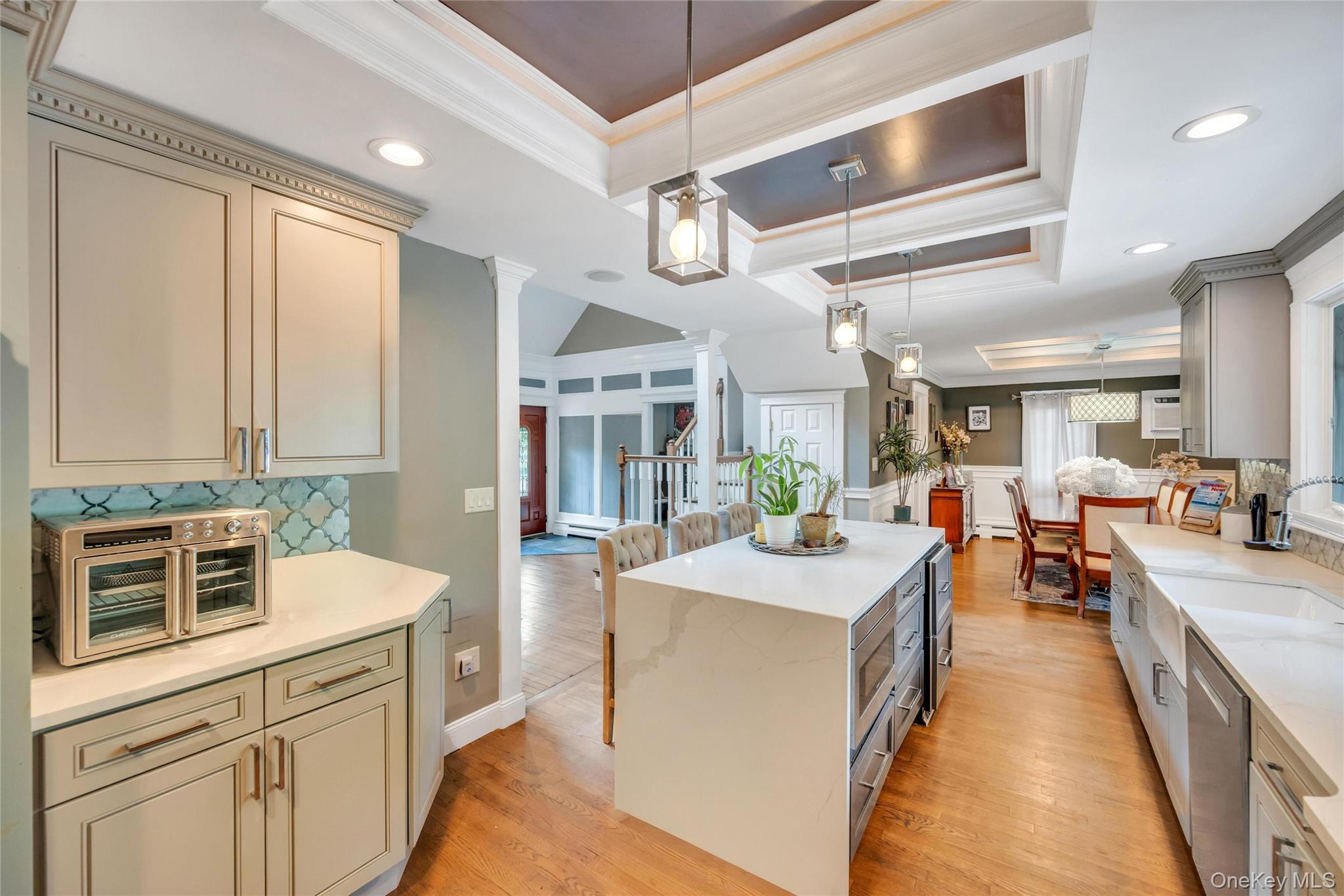 19 Joan Road Bay Shore, NY 11706 - Photo 12 of 50 Kitchen featuring an oversized island with waterfall countertop, recessed lighting, and tray ceiling