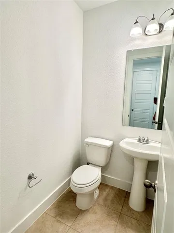 a white toilet sitting next to a bathroom sink
