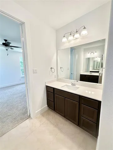 a view of an empty room with window and cabinet
