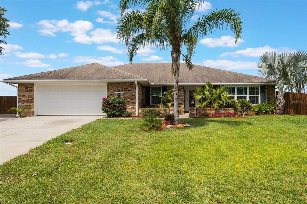 1802 Concert Road Deltona, FL 32738 - Photo 1 of 1 a front view of a house with garden