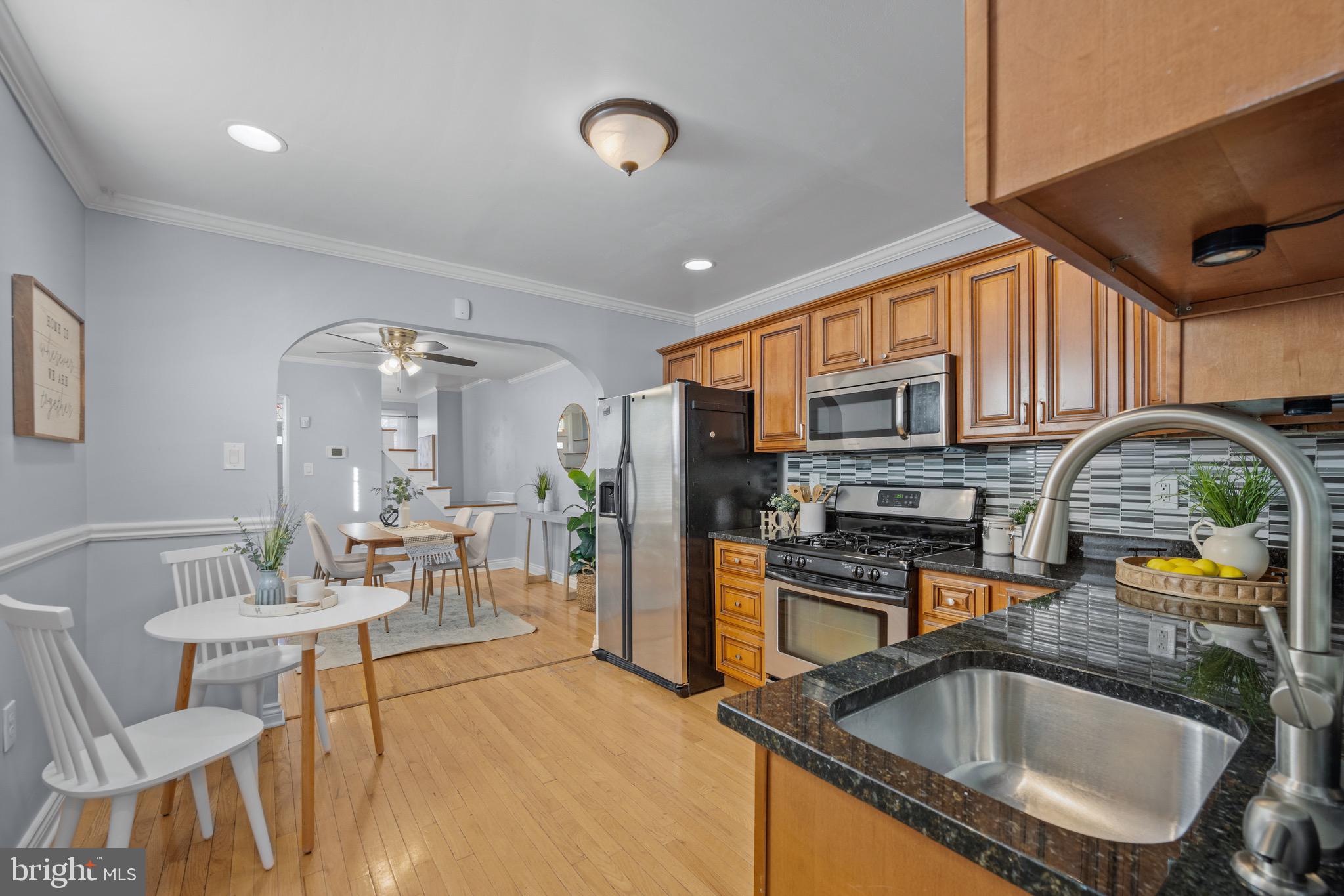 17 West Fort Avenue Baltimore, MD 21230 - Photo 11 of 43 a kitchen with stainless steel appliances granite countertop a sink a stove and a refrigerator