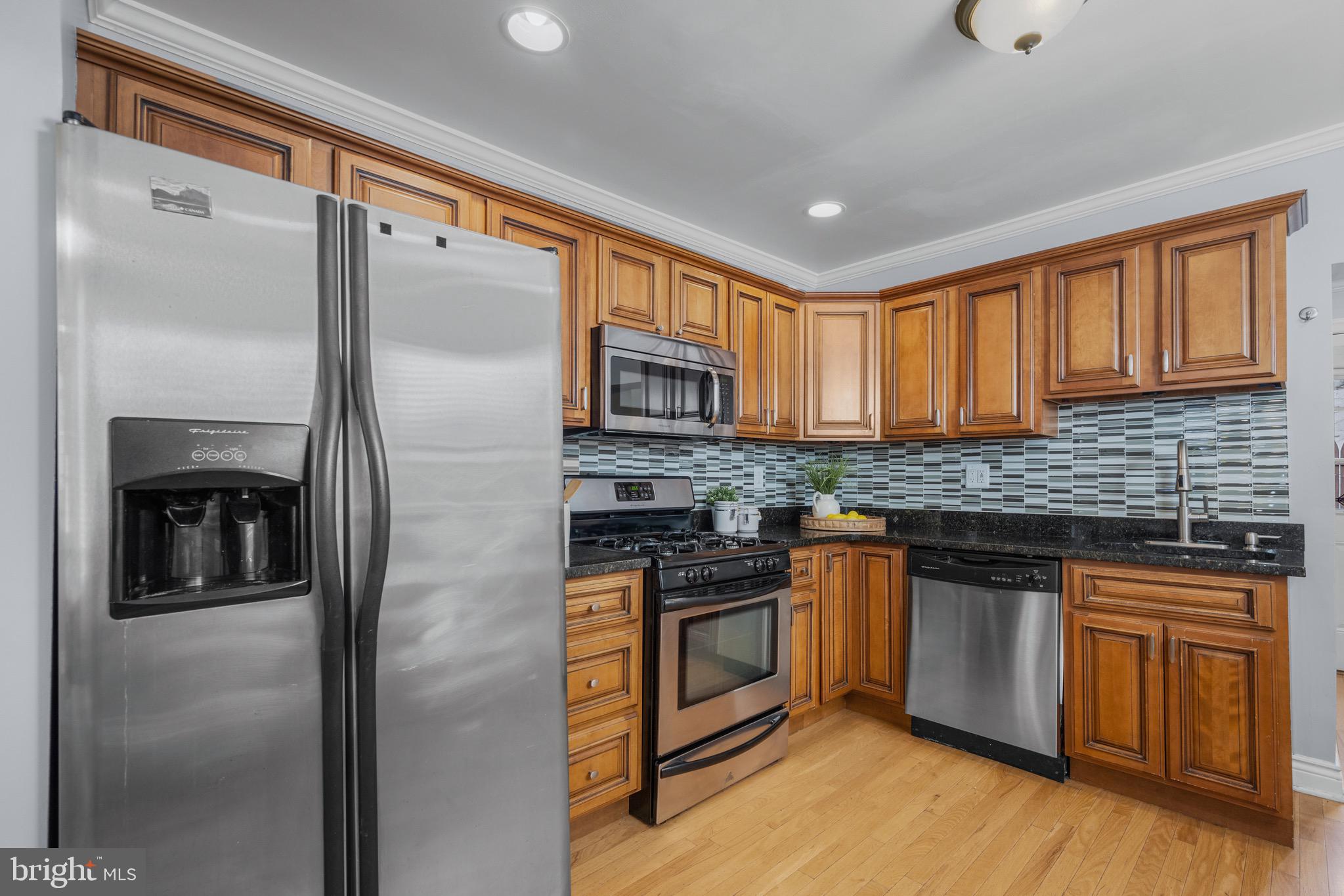 17 West Fort Avenue Baltimore, MD 21230 - Photo 12 of 43 a kitchen with stainless steel appliances granite countertop a refrigerator a stove a sink and a microwave