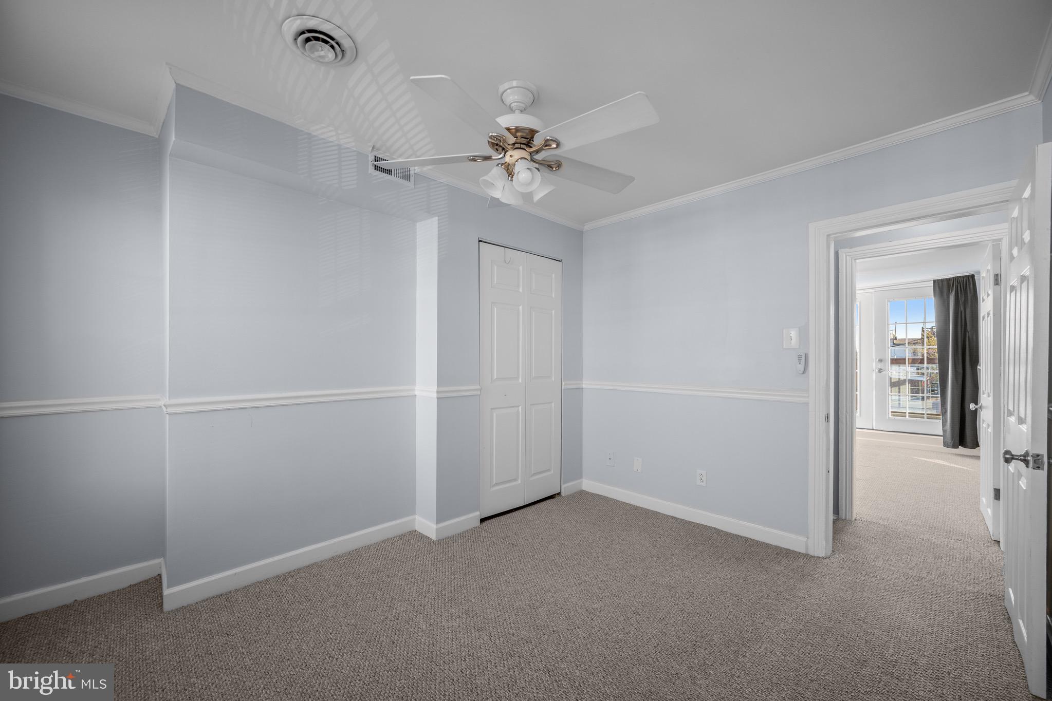17 West Fort Avenue Baltimore, MD 21230 - Photo 25 of 43 an empty room with a chandelier fan and windows