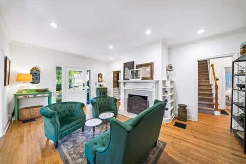 a living room with furniture and a wooden floor