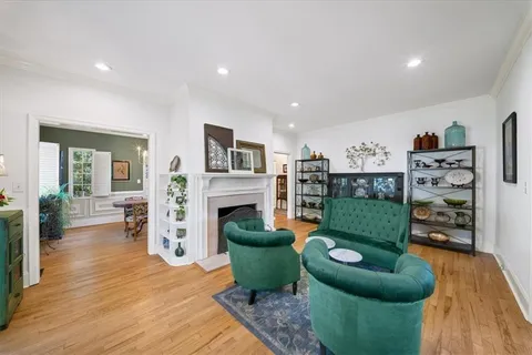 a living room with fireplace furniture and a wooden floor
