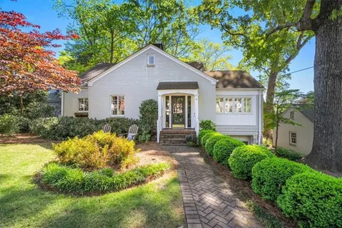 a view of backyard of house with green space