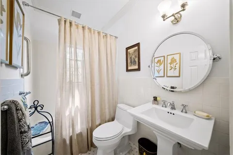 a dining room with furniture a chandelier and wooden floor